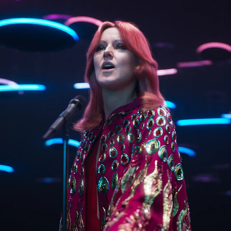 A digital ABBA avatar in a sequinned red jacket sings in ABBA Voyage, ABBA Arena
