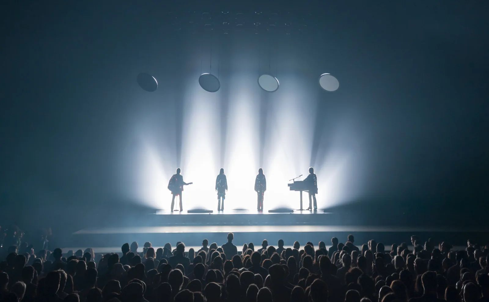ABBA in silhouette with guitars and keyboard in white light, ABBA Voyage, ABBA Arena
