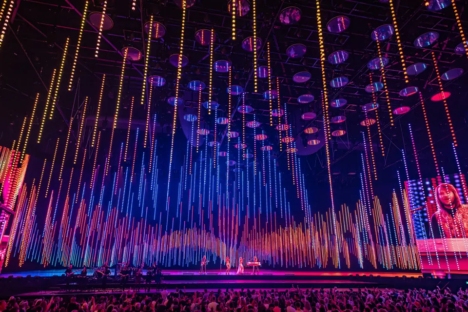 Curtains of coloured light rain down during Dancing Queen, ABBA Voyage, ABBA Arena