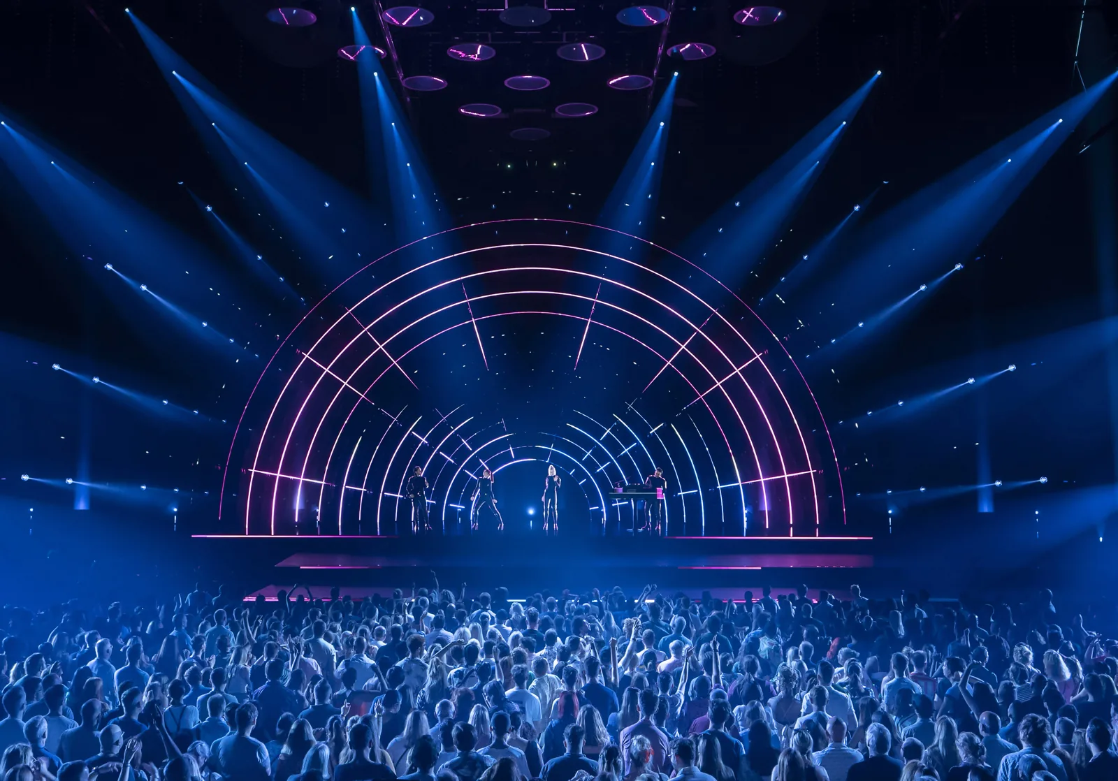 Neon arches and blue light beams frame Gimme! Gimme! Gimme! in ABBA Voyage, ABBA Arena
