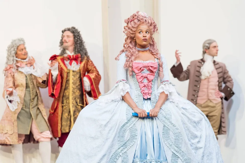 Celia in a blue gown and pink wig, As You Like It, Shakespeare's Globe