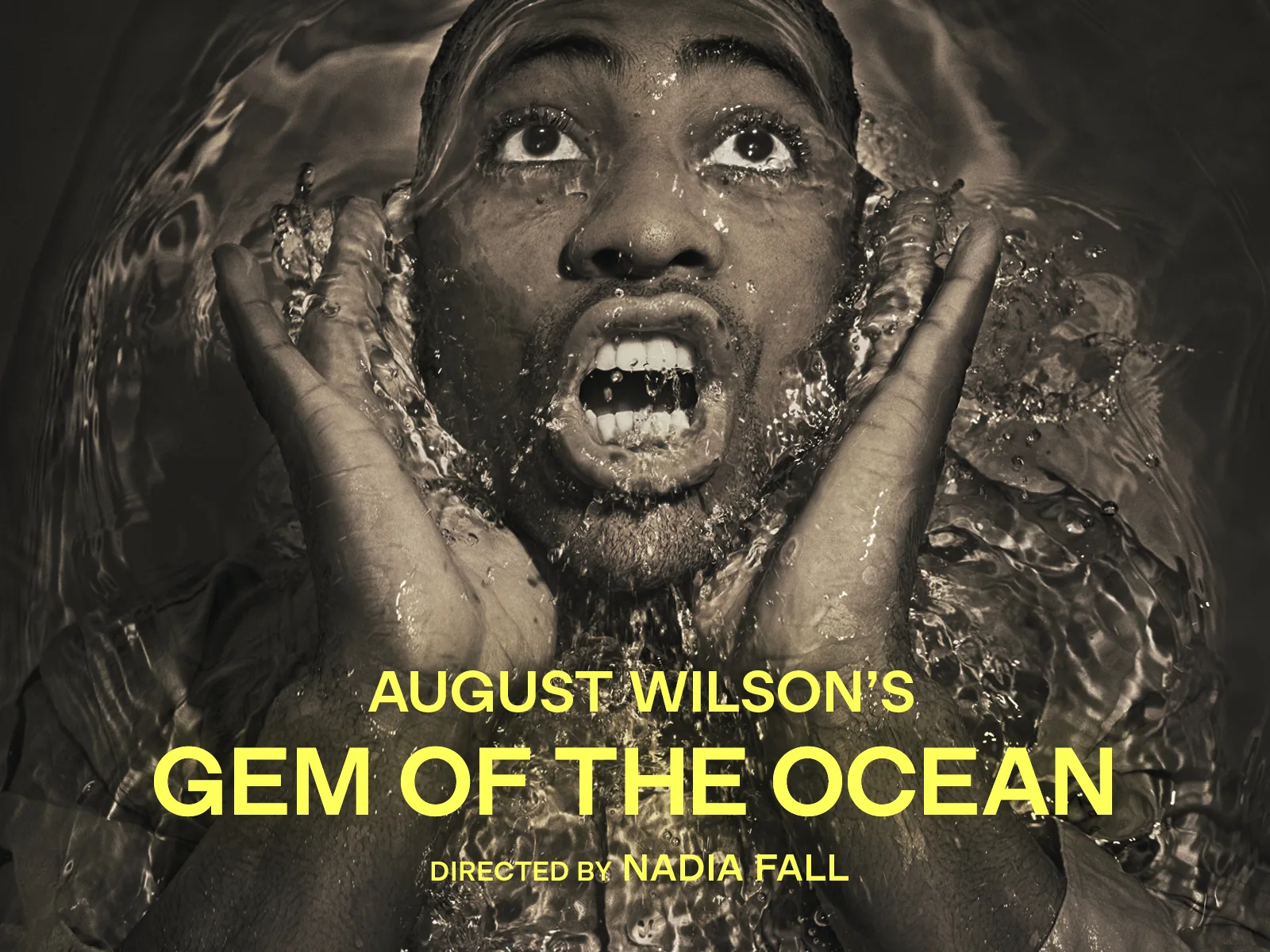 Man with water splashing across face and hands in August Wilson's Gem of the Ocean at the Young Vic (Main House)