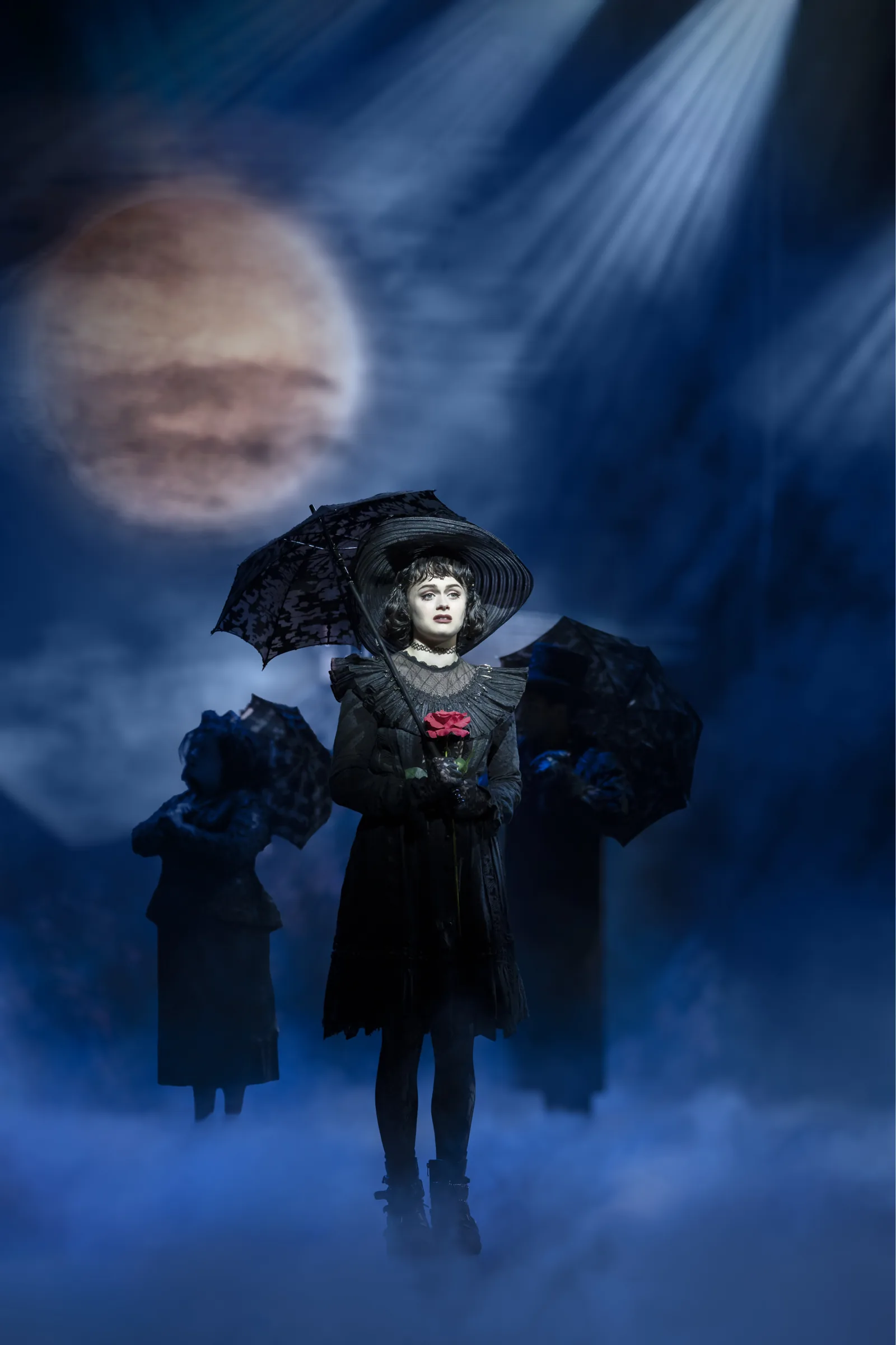 Hannah Nordberg as Lydia holds a red rose by moonlight, Beetlejuice, Prince Edward Theatre