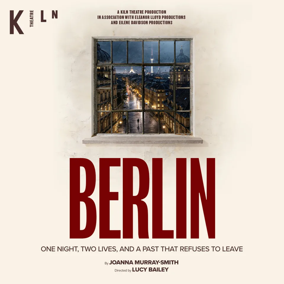 Lit Berlin street at night framed by window in Berlin at the Kiln Theatre