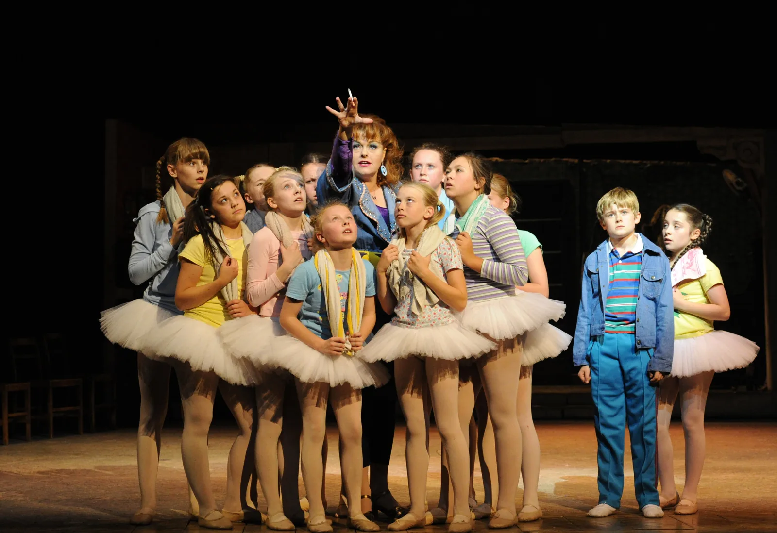 Ballet Girls in tutus gather round their teacher in Billy Elliot the Musical