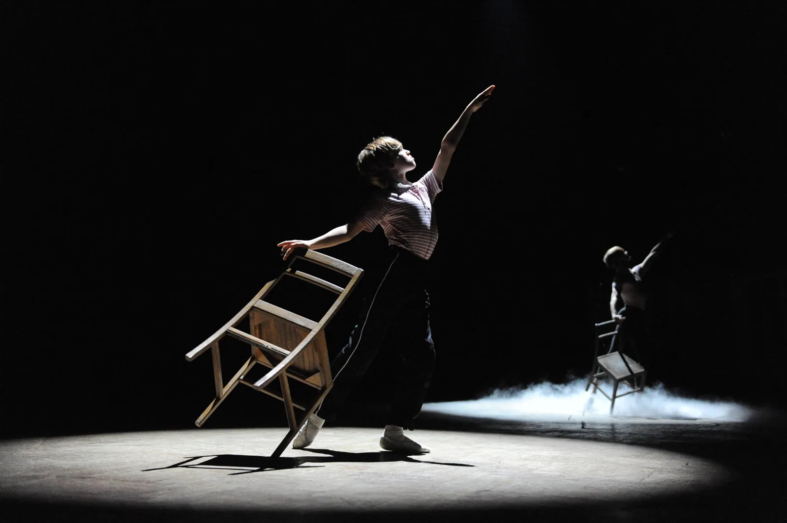 Billy dances with a wooden chair in a pool of light, Billy Elliot the Musical