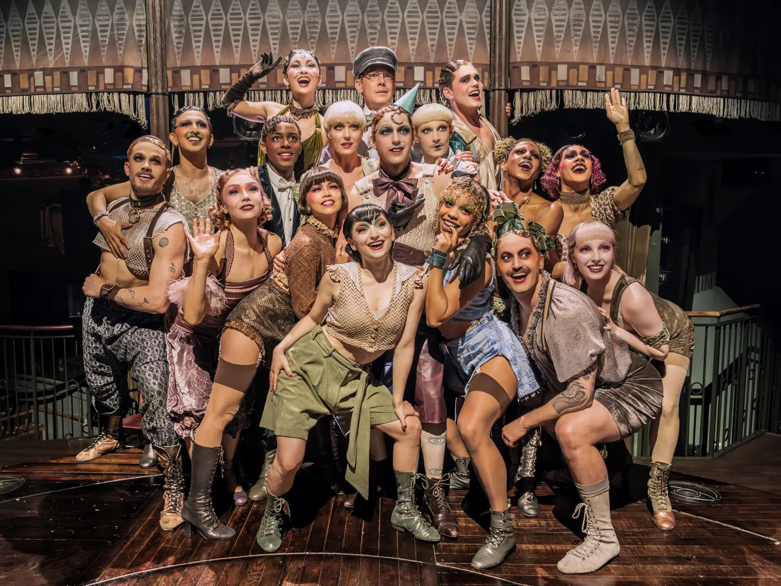The company pile together in costume on stage in Cabaret, Kit Kat Club