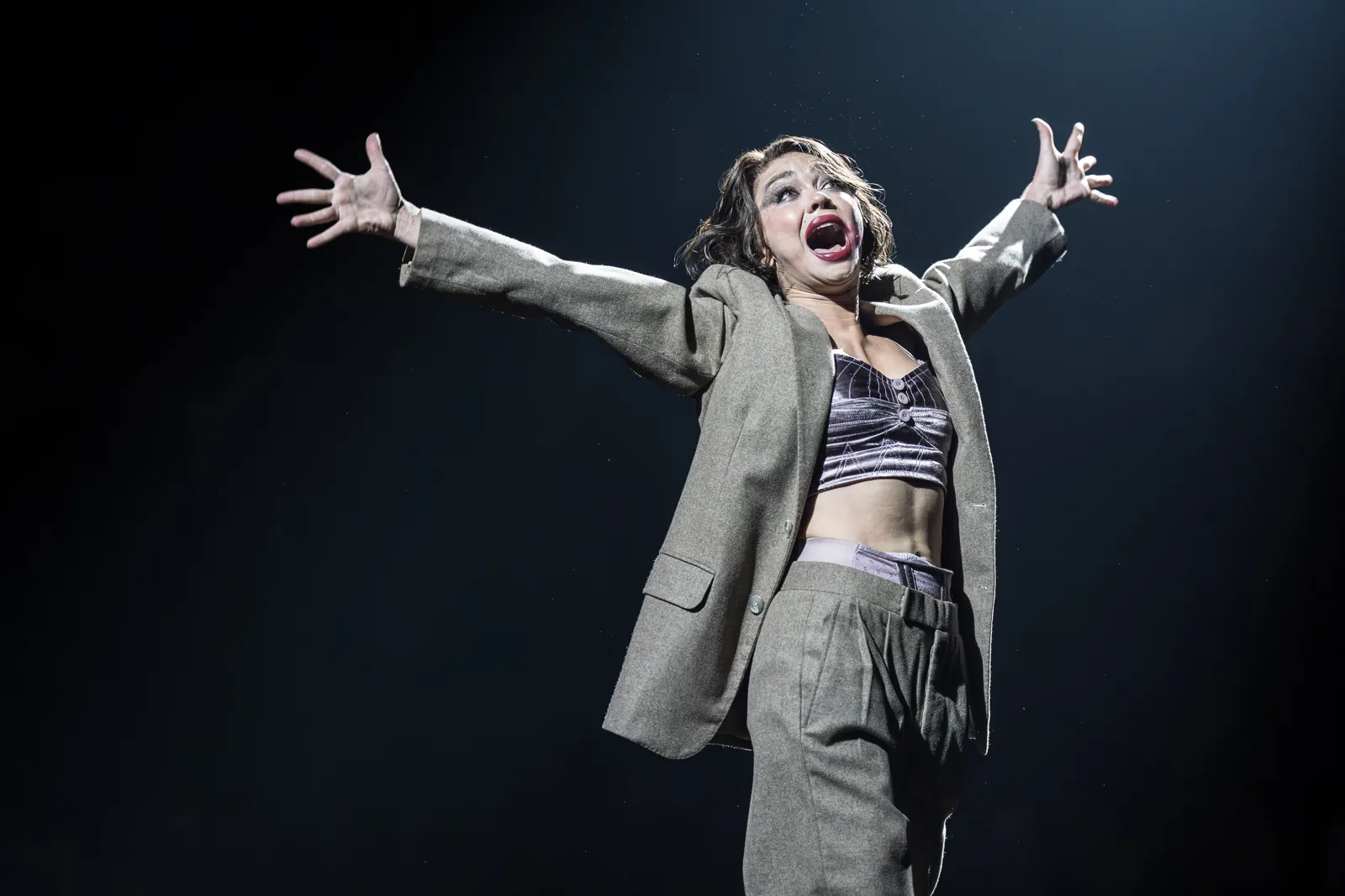 Sarah Hyland as Sally Bowles sings, arms flung wide, Cabaret at the Kit Kat Club