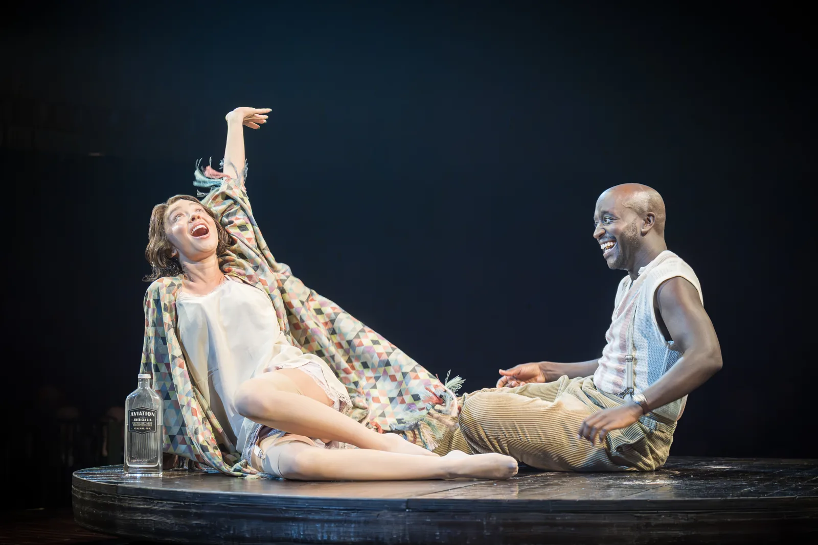 Sarah Hyland and Baker Mukasa laugh together on the round stage, Cabaret, Kit Kat Club