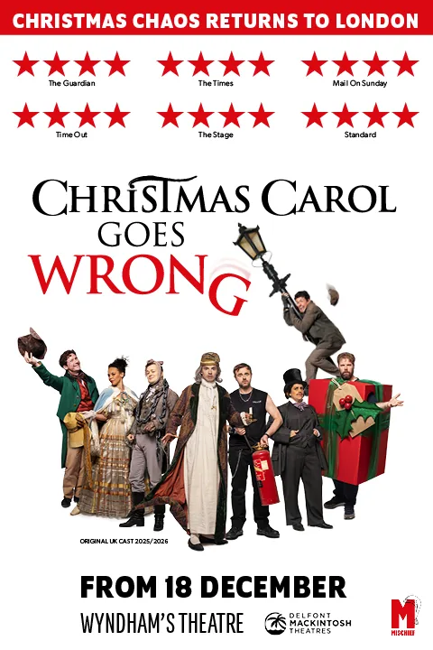 The cast in costume, one hanging from a lamppost, Christmas Carol Goes Wrong, Wyndham's Theatre