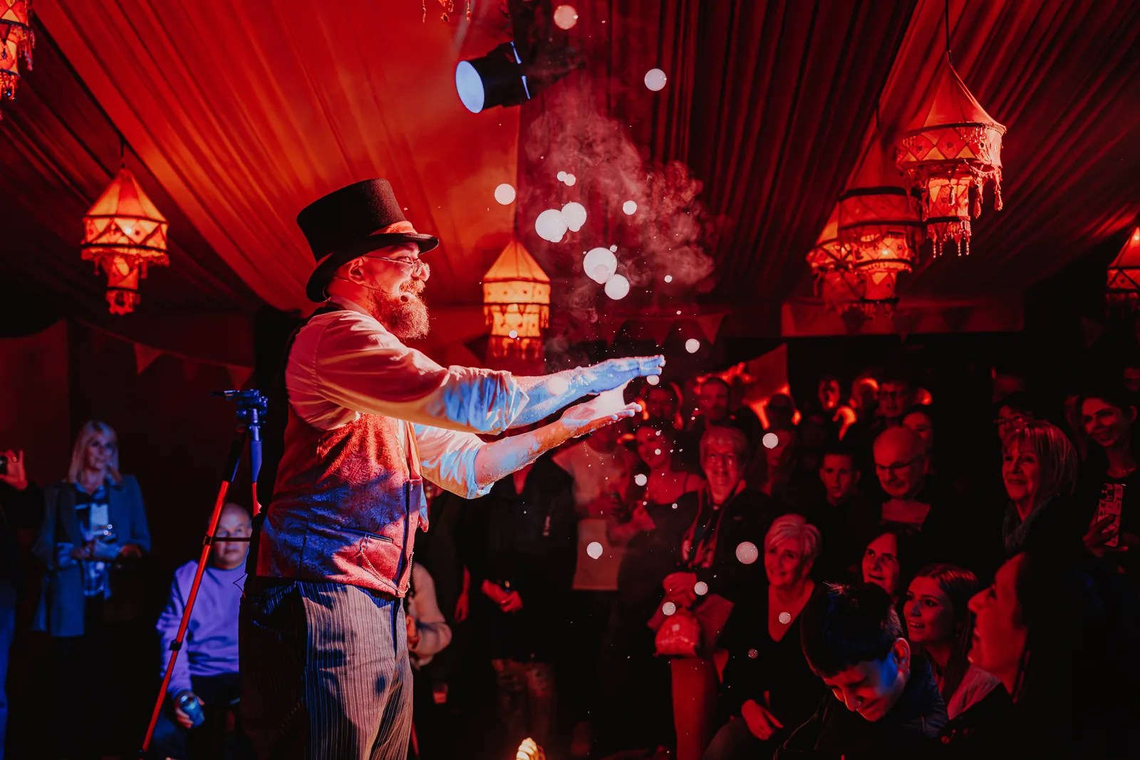 A top-hatted performer sends floating orbs over the audience, Come Alive!, Empress Museum