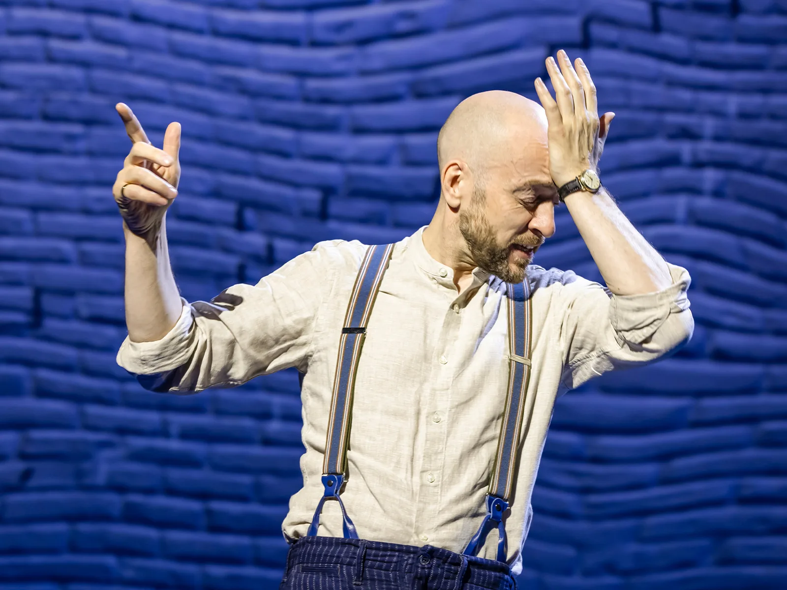 Derren Brown, sleeves rolled up, one hand to his head, Only Human at the Apollo Theatre