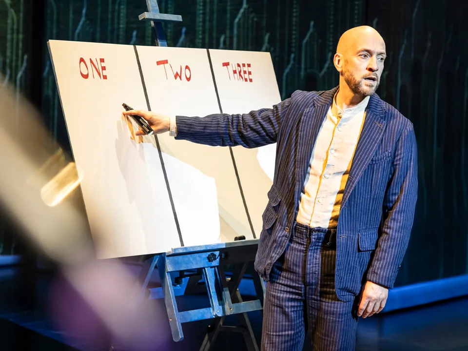 Derren Brown writes on a board marked One, Two, Three, Only Human at the Apollo Theatre
