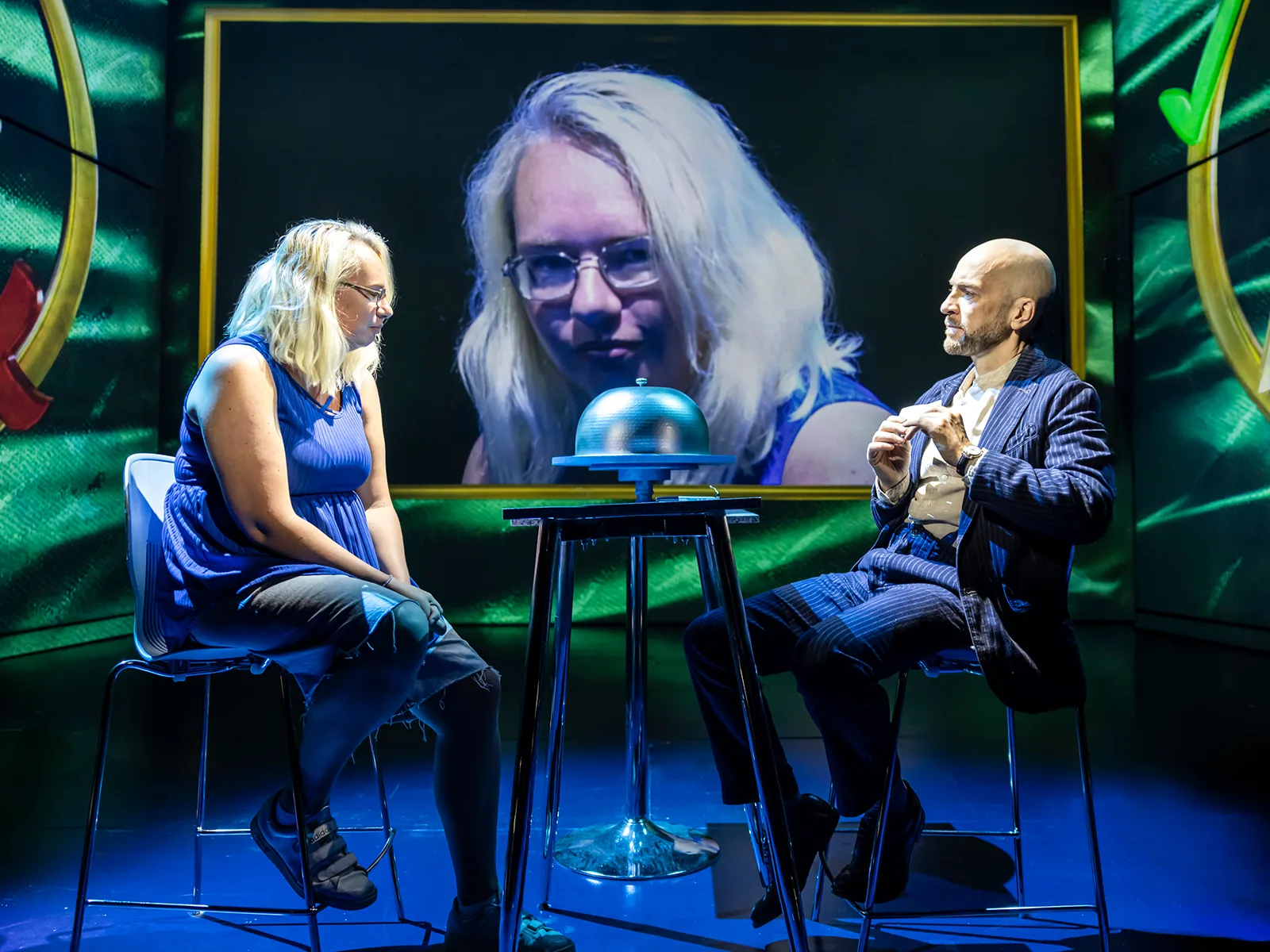Derren Brown sits opposite a volunteer, her face on a big screen behind them, Only Human at the Apollo Theatre