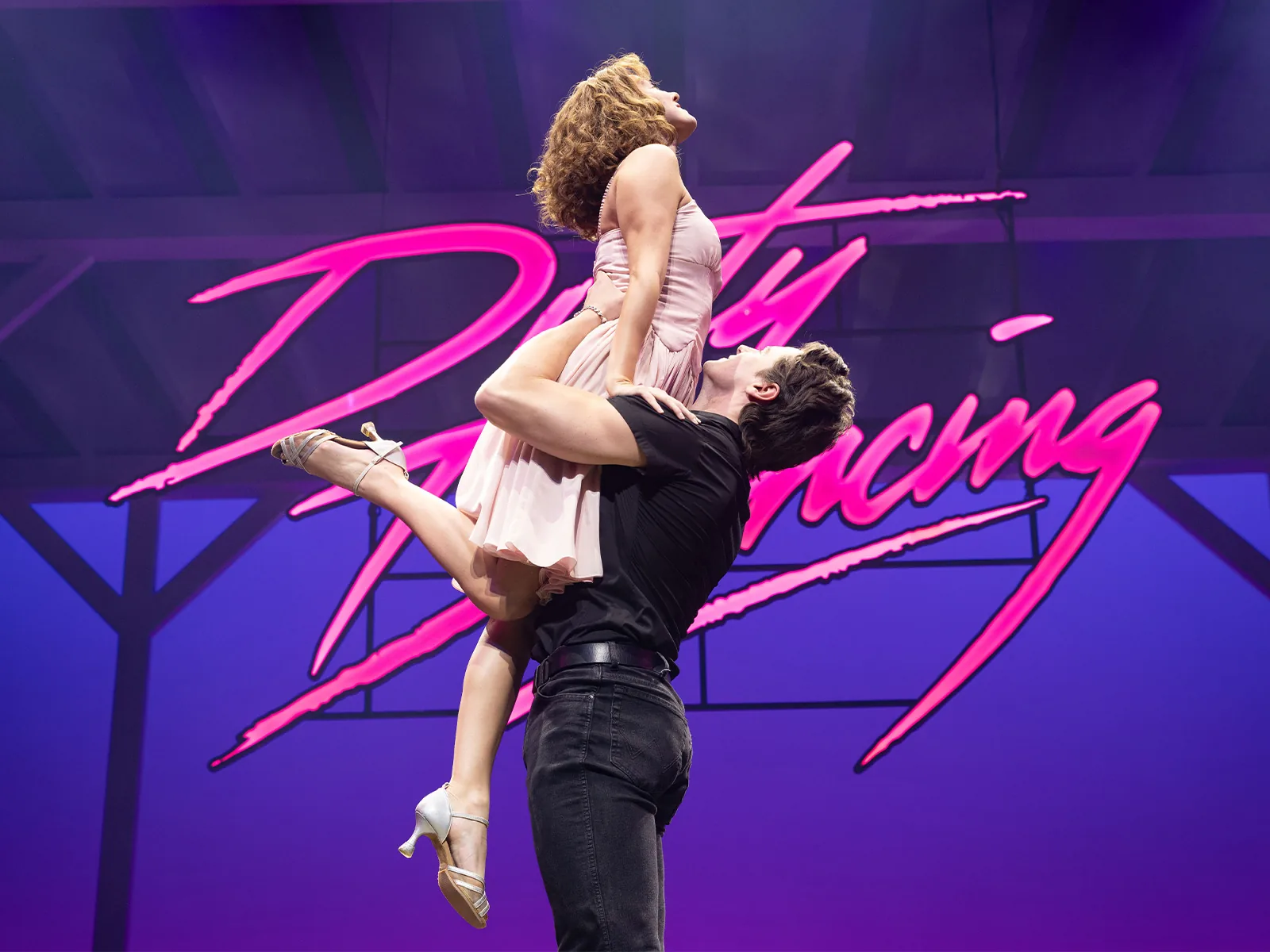 Dirty Dancing artwork: a dancer lifted before a neon pink sign, Prince Edward Theatre