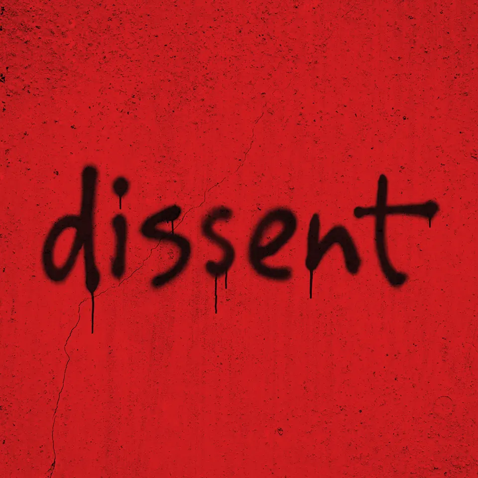 Red background with black spray-paint text in dissent at the Young Vic (Main House)