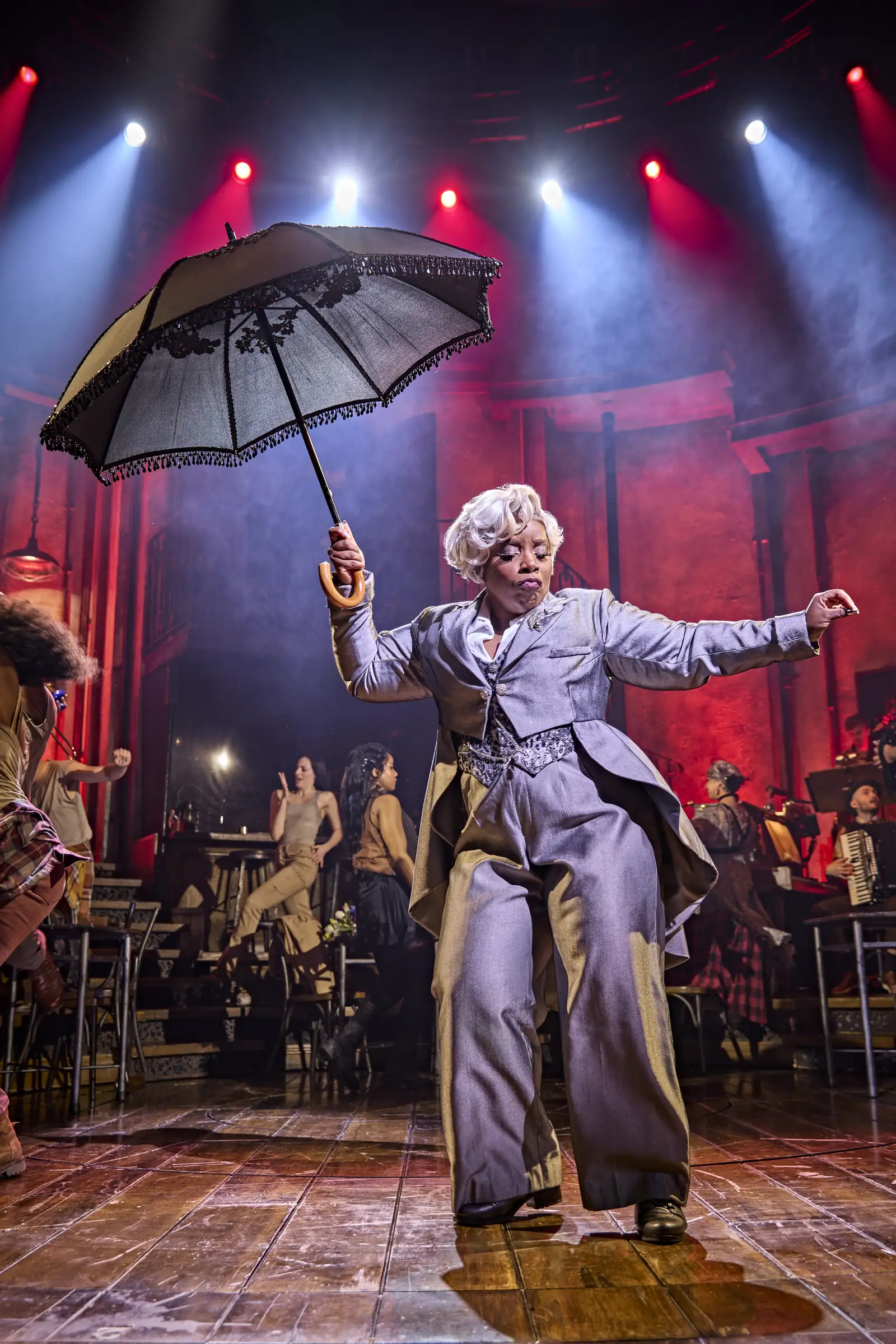 Malinda Parris as Hermes twirls a lace parasol, Hadestown, Lyric Theatre