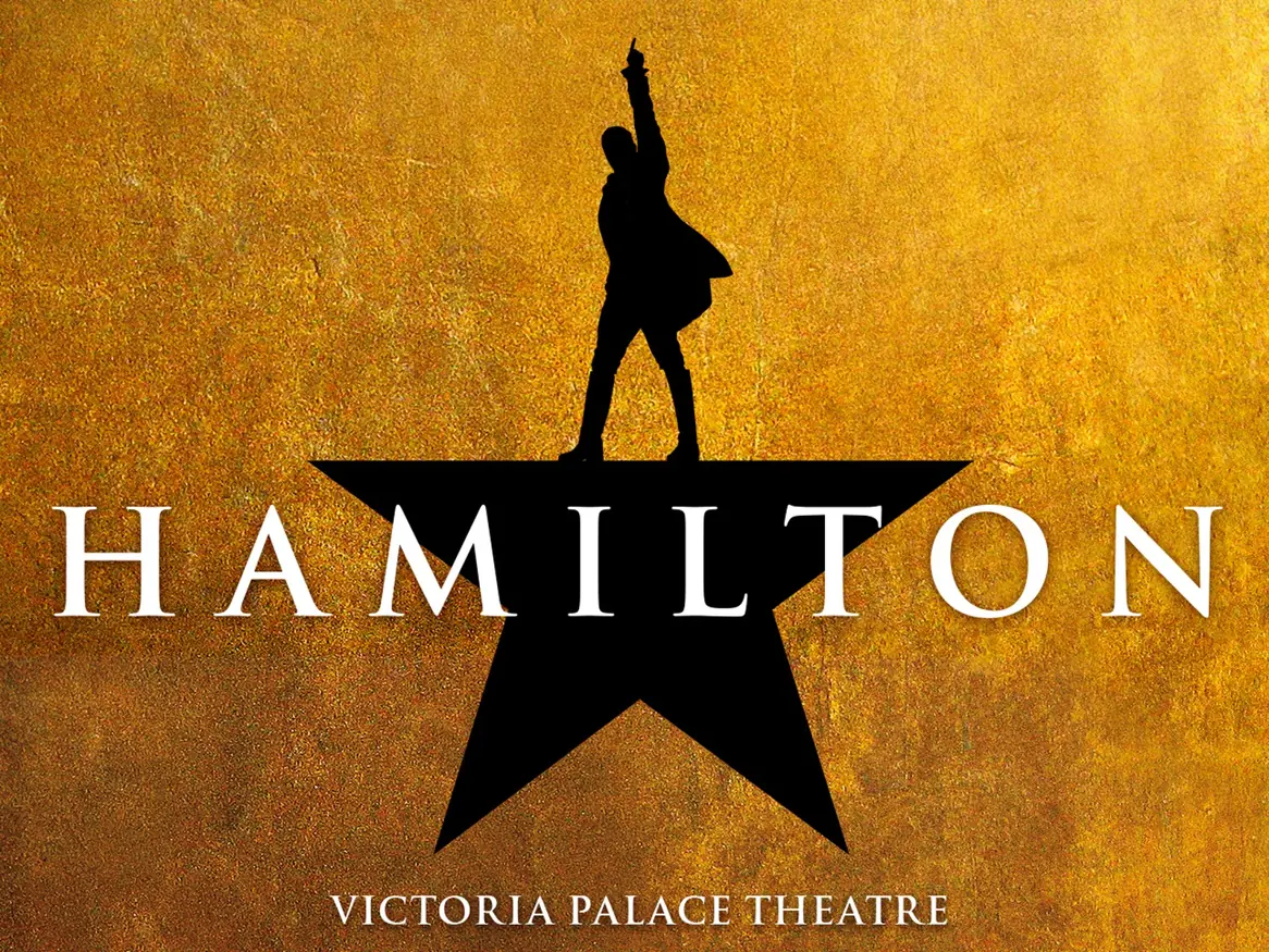 Wide Hamilton artwork: the star and silhouette logo on gold, Victoria Palace Theatre