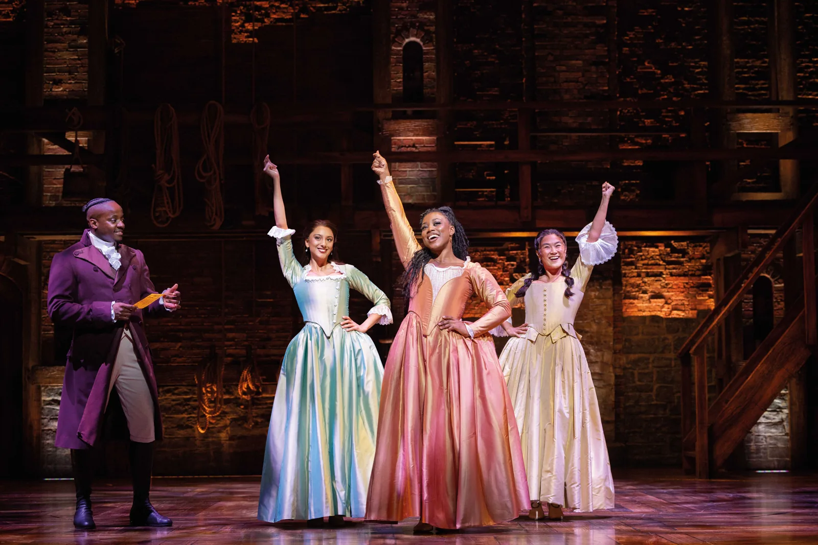 Yeukayi Ushe as Burr with the three Schuyler sisters in Hamilton, Victoria Palace Theatre
