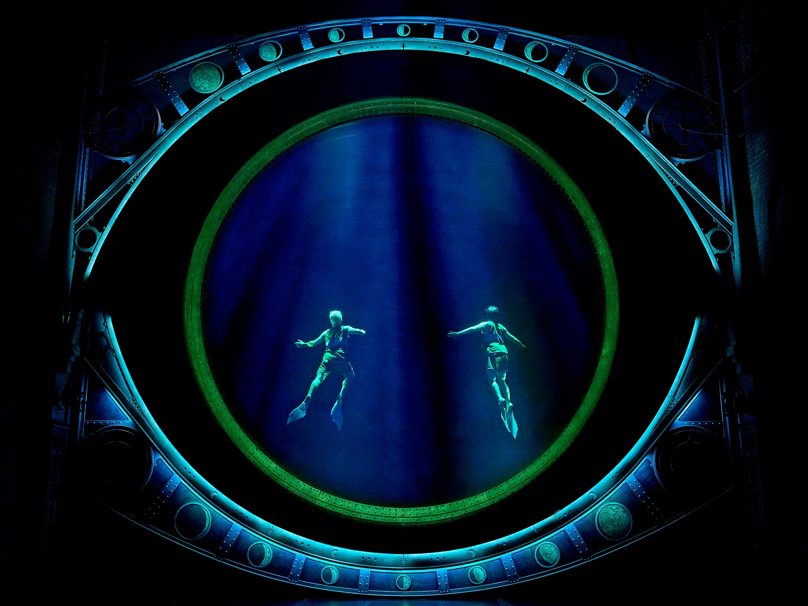 Two figures seem to swim inside a glowing ring, Cursed Child at the Palace Theatre