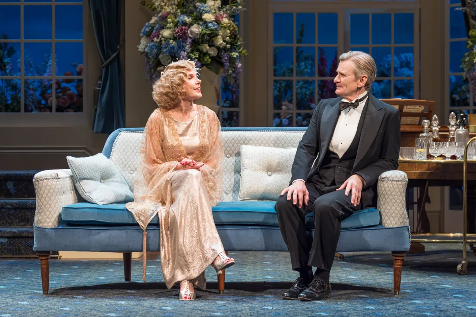 Christine Baranski and Charles Edwards on a blue sofa, Hay Fever, Wyndham's