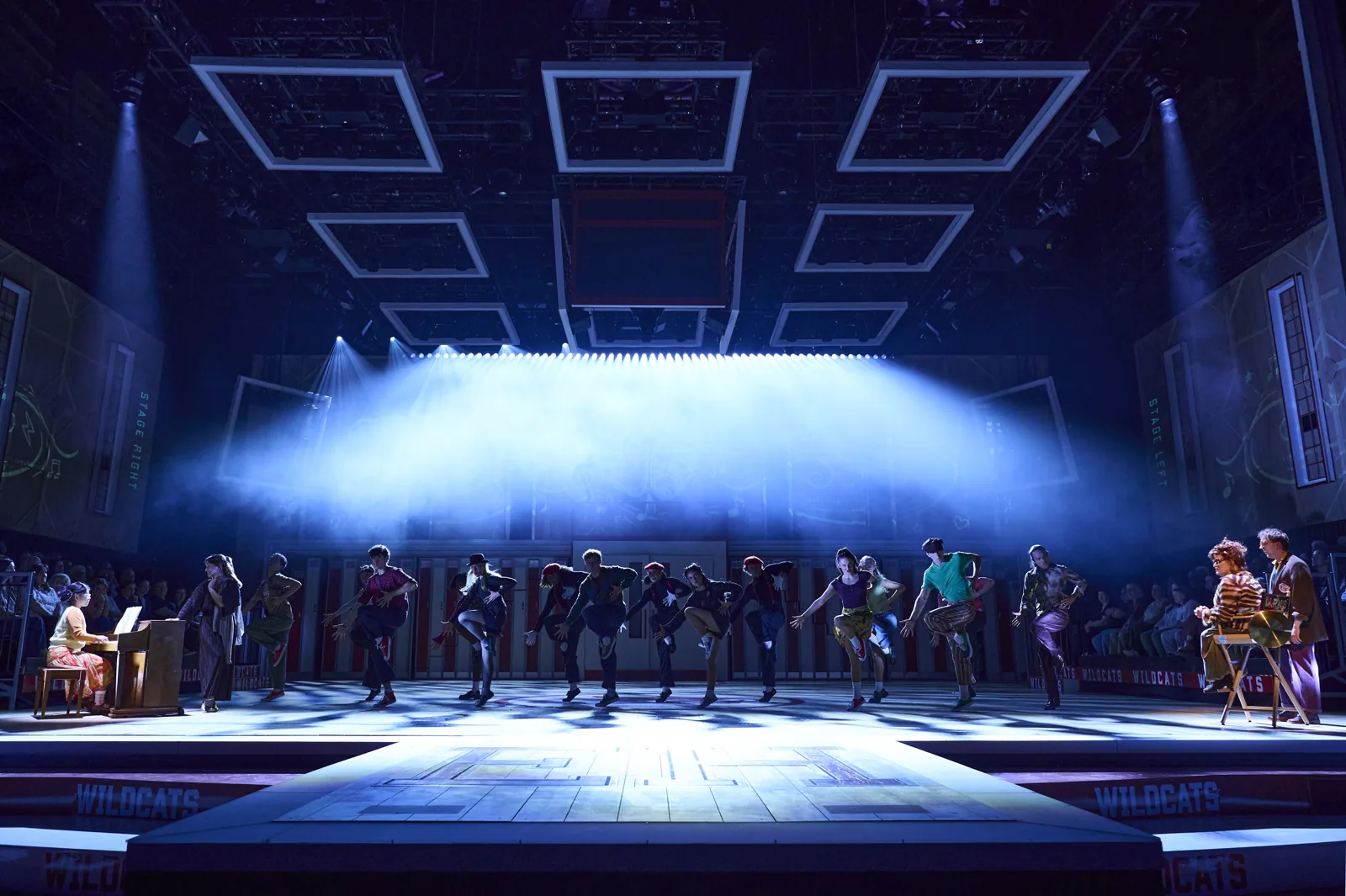 The full company lined up in blue light, High School Musical, Troubadour Wembley Park
