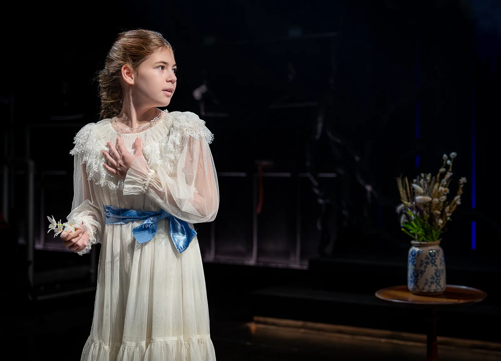 A young girl in white lace and a blue sash, Jane Eyre, Southwark Playhouse