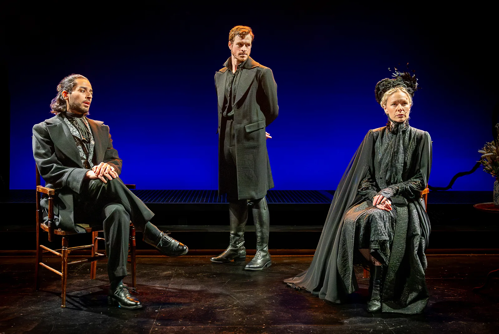 Two seated figures and a man standing between them, Jane Eyre, Southwark Playhouse