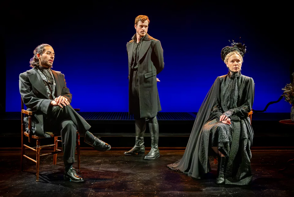 Two seated figures and a man standing between them, Jane Eyre, Southwark Playhouse