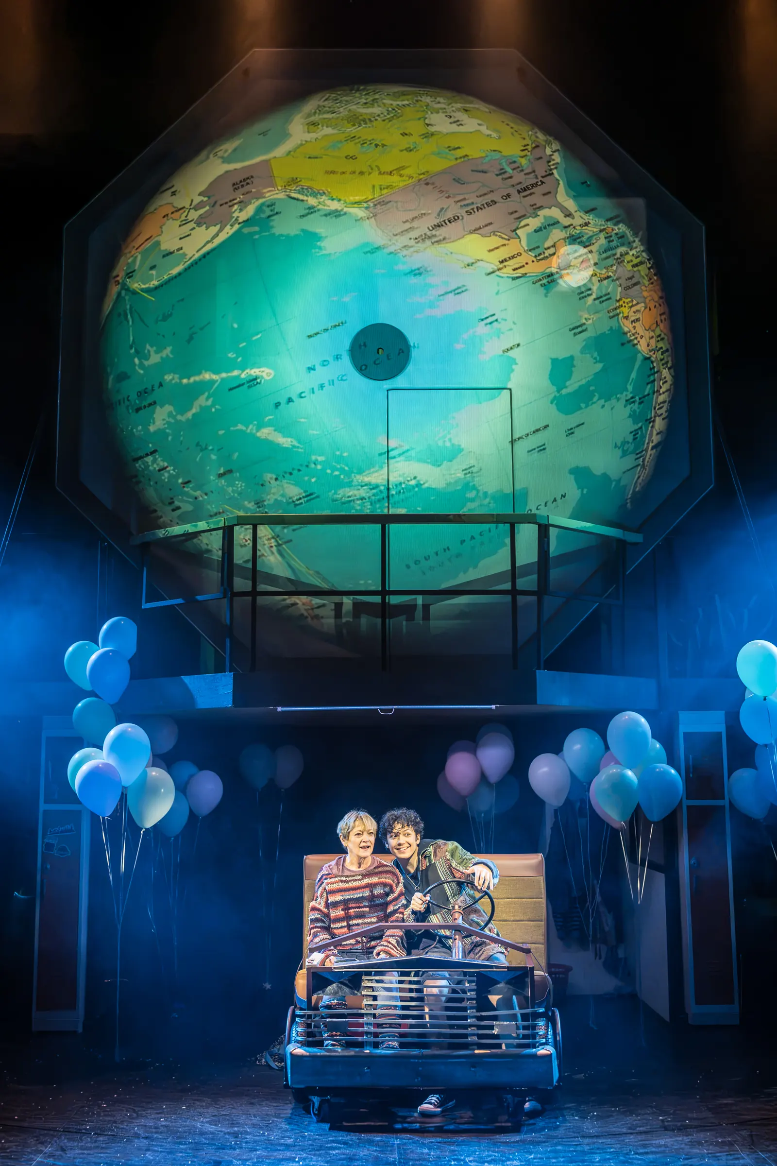 Kimberly and a friend in the car under a giant globe, Kimberly Akimbo, Hampstead