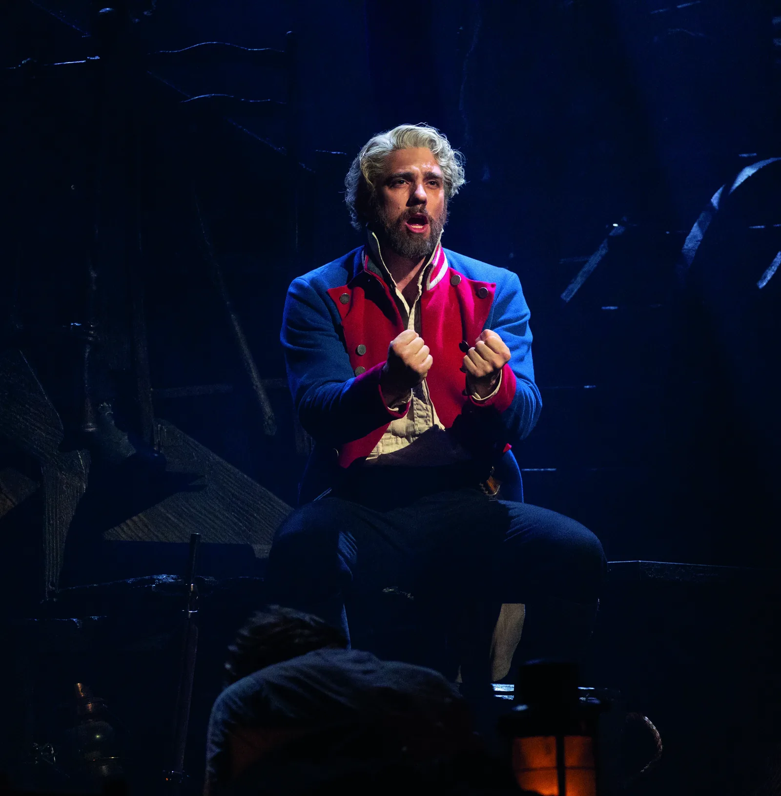 Ian McIntosh as Jean Valjean sings, fists clenched, in Les Misérables at the Sondheim Theatre