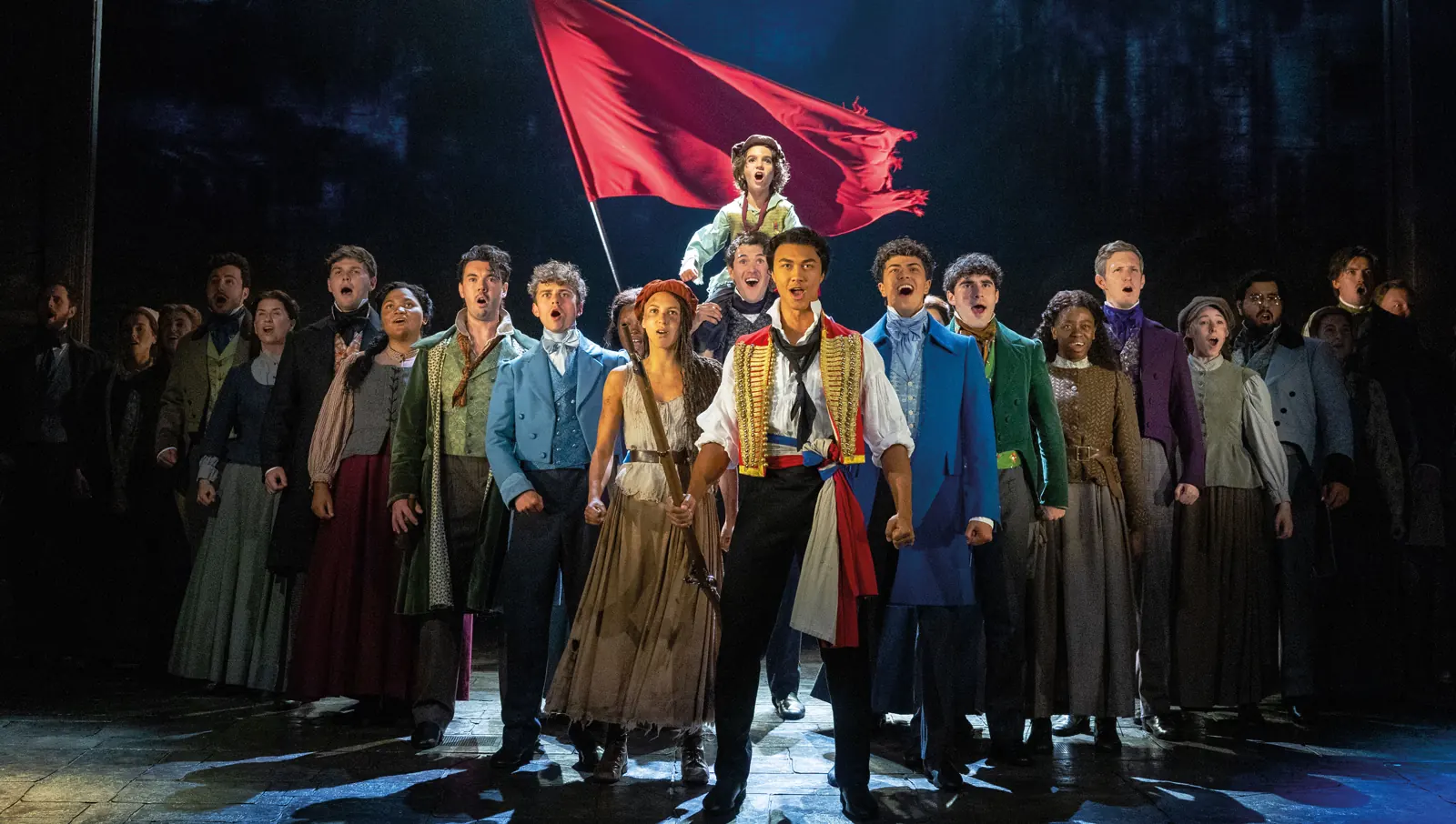 The company sings One Day More in Les Misérables at the Sondheim Theatre