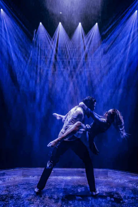 A dancer dips a woman backwards under rain, Magic Mike Live, Hippodrome Casino