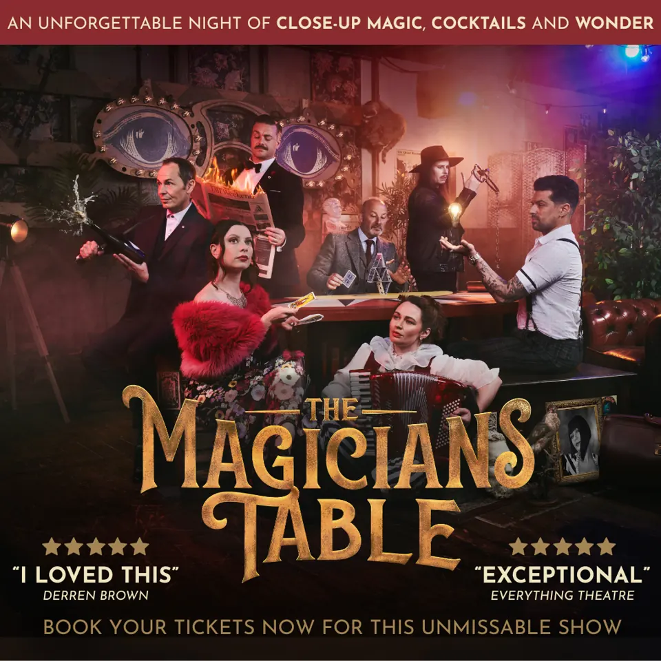 Seven performers around magic table in The Magicians Table at the The Vaults Theatre