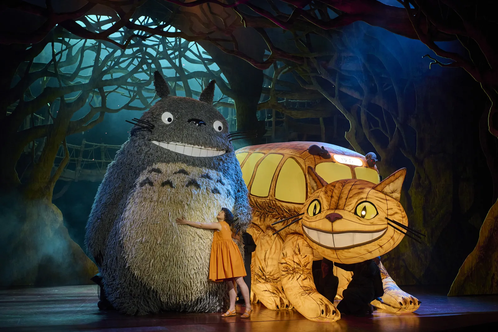 Satsuki hugs Totoro beside the grinning Catbus in My Neighbour Totoro, Gillian Lynne Theatre