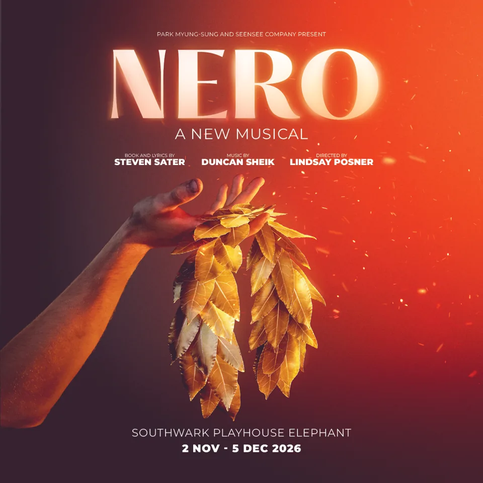 Hand holding golden leaves against red in Nero at the Southwark Playhouse Elephant