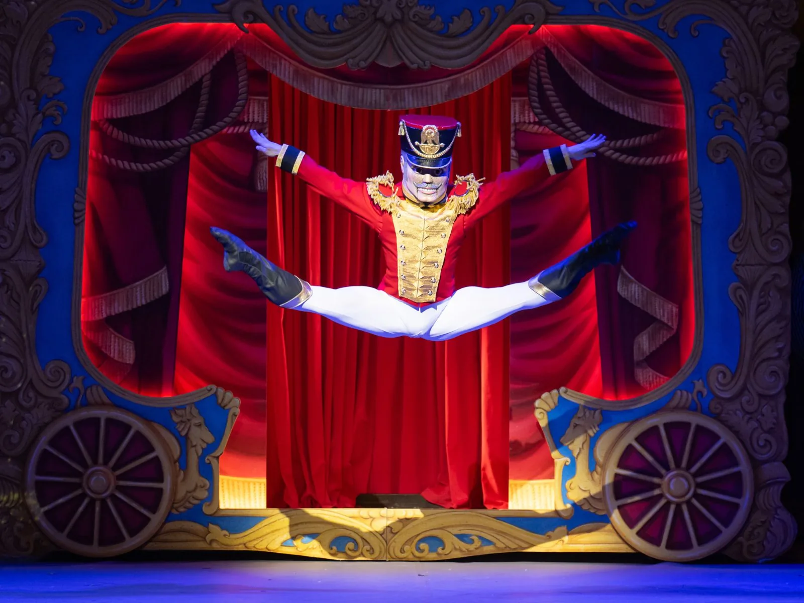 The Nutcracker Doll leaps from a red-curtained toy theatre in Nutcracker, London Coliseum