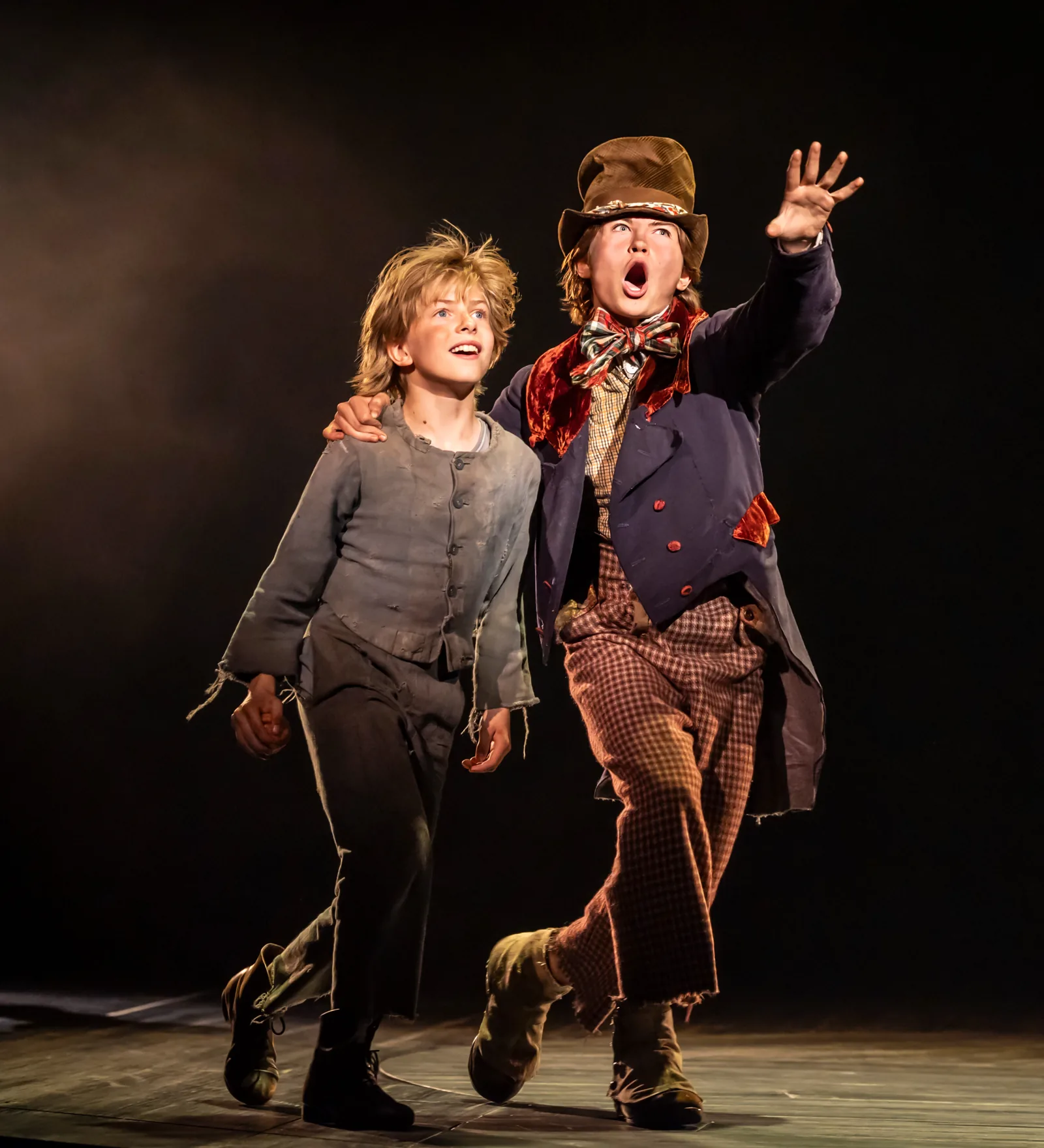 The Artful Dodger takes Oliver under his arm in Oliver! at the Gielgud Theatre