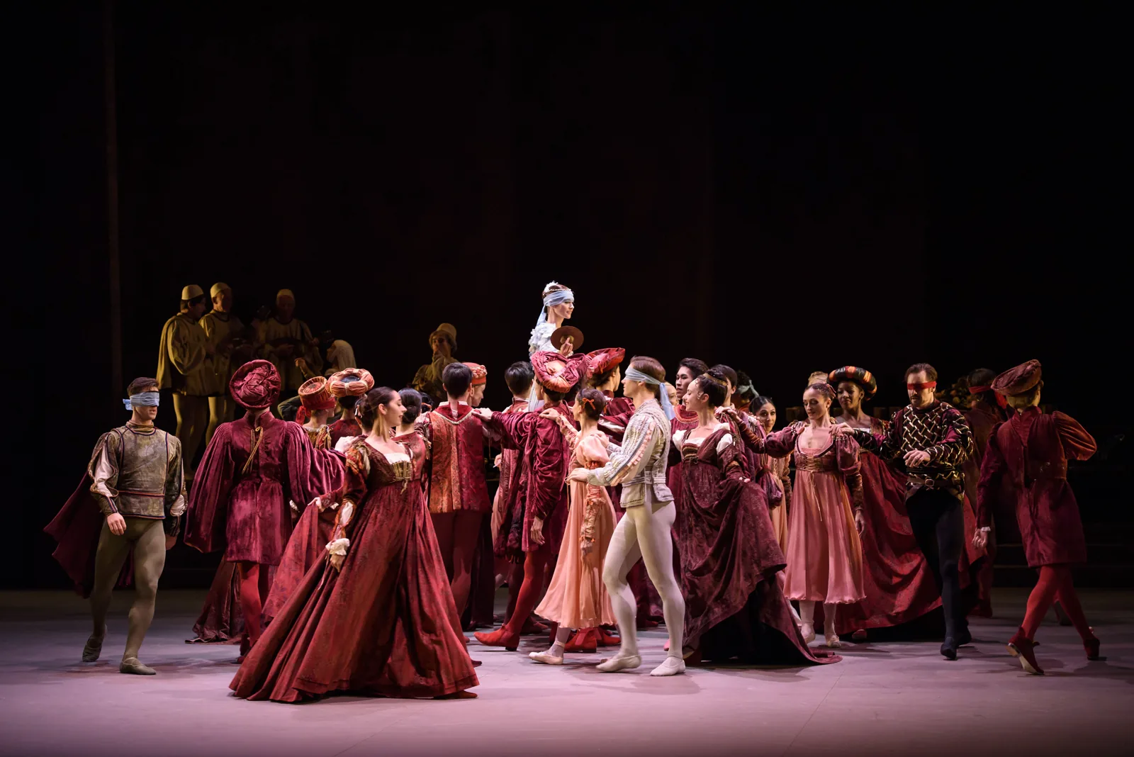 The full company in burgundy and rose on the stage, Romeo & Juliet, London Coliseum