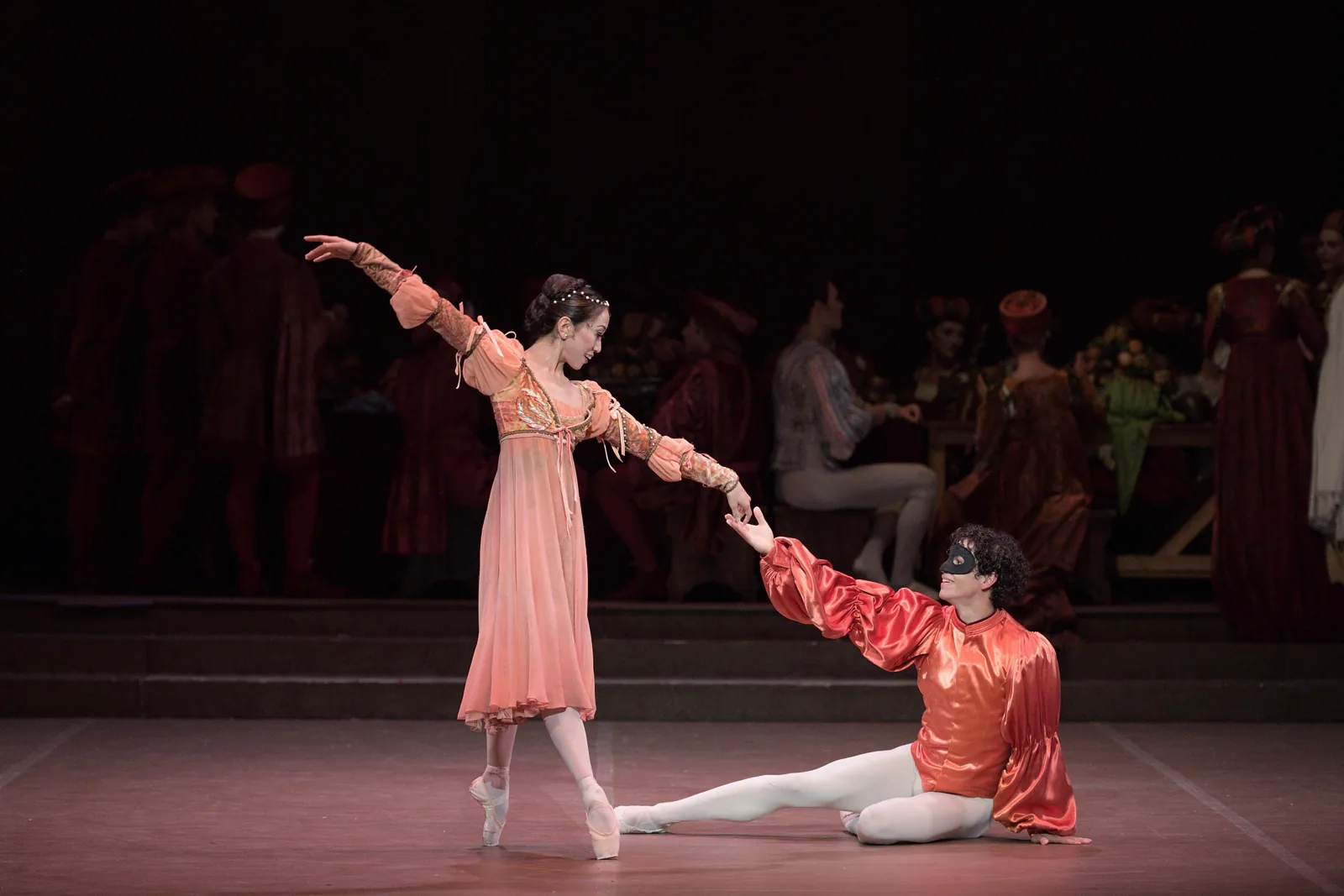 Juliet dances as a masked Romeo reaches for her hand, Romeo & Juliet, London Coliseum