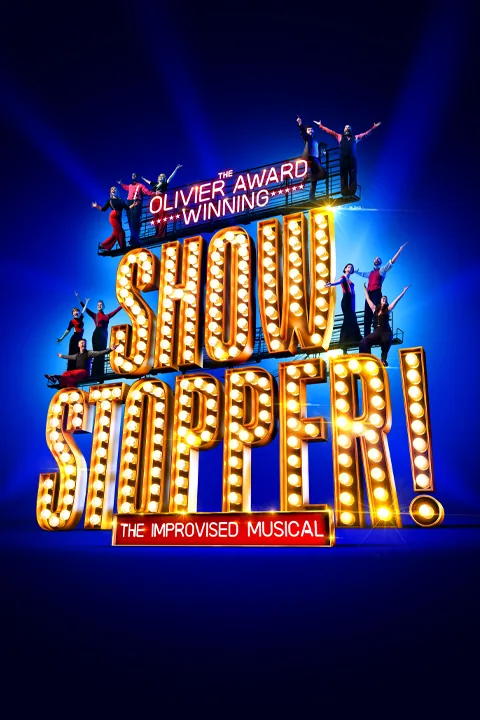 Golden marquee lettering and celebrating performers in Showstopper! The Improvised Musical at the Cambridge Theatre