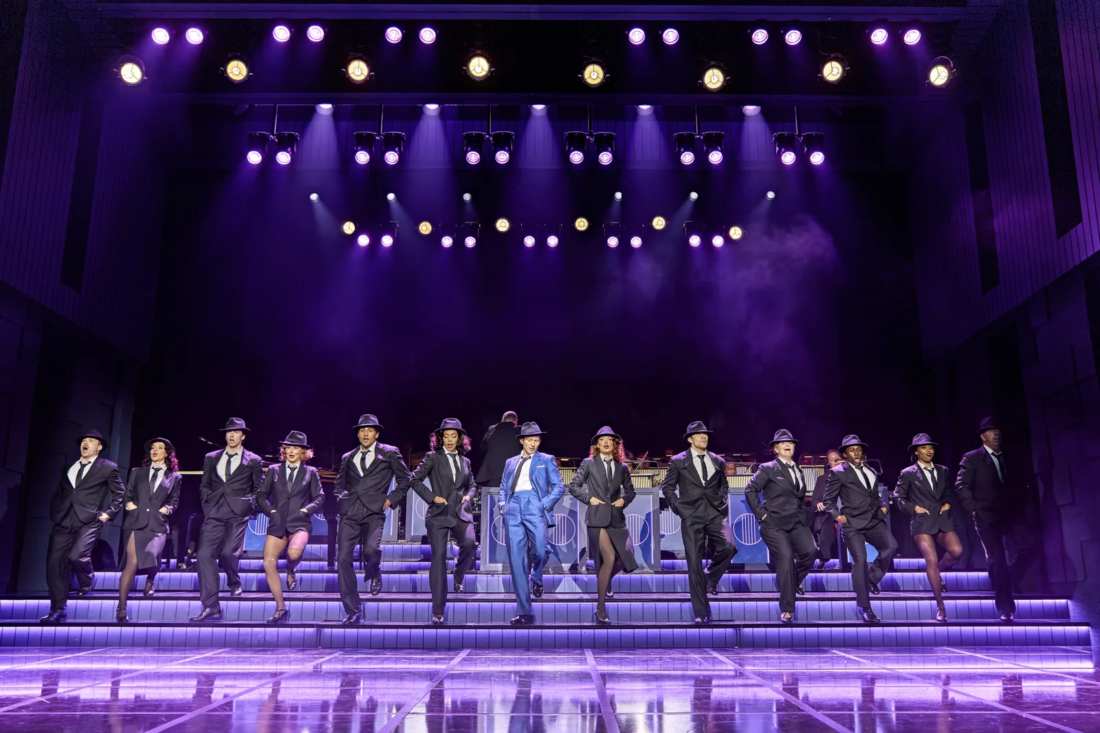 Joel Harper-Jackson and the ensemble dance in a line in Sinatra The Musical, Aldwych Theatre