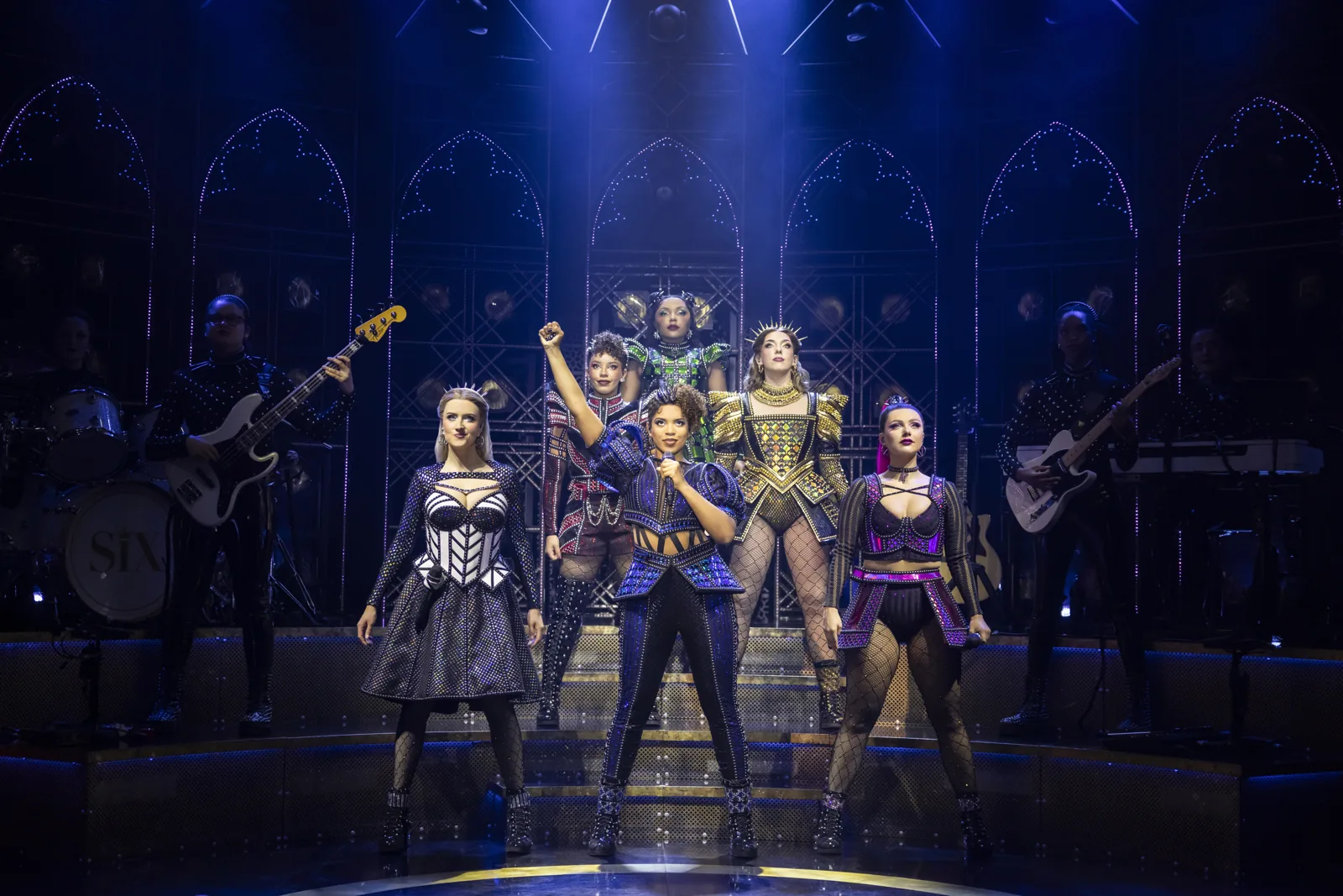 The six queens stand in formation with the band behind, SIX at the Vaudeville Theatre