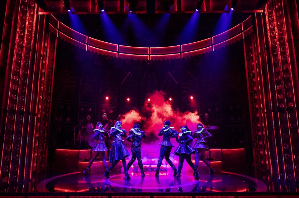 Six queens in purple ruffs dance through pink smoke, SIX at the Vaudeville Theatre