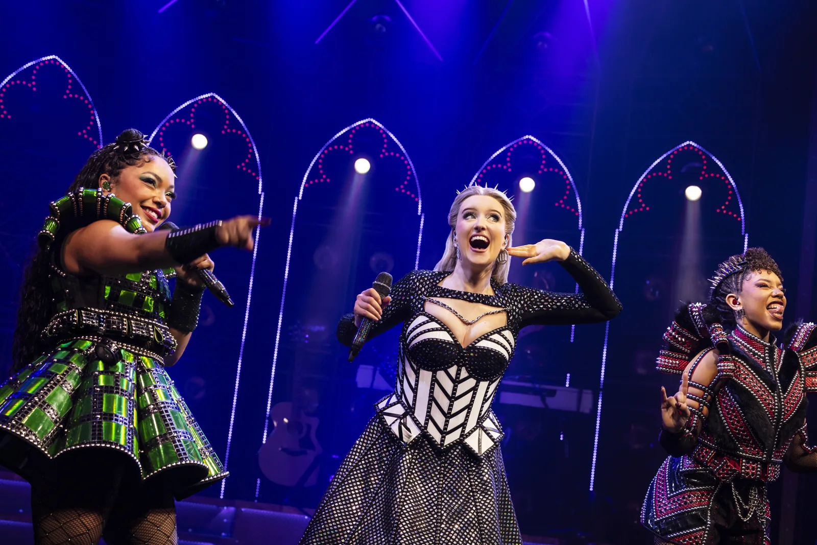 Three queens sing and point towards the audience, SIX at the Vaudeville Theatre