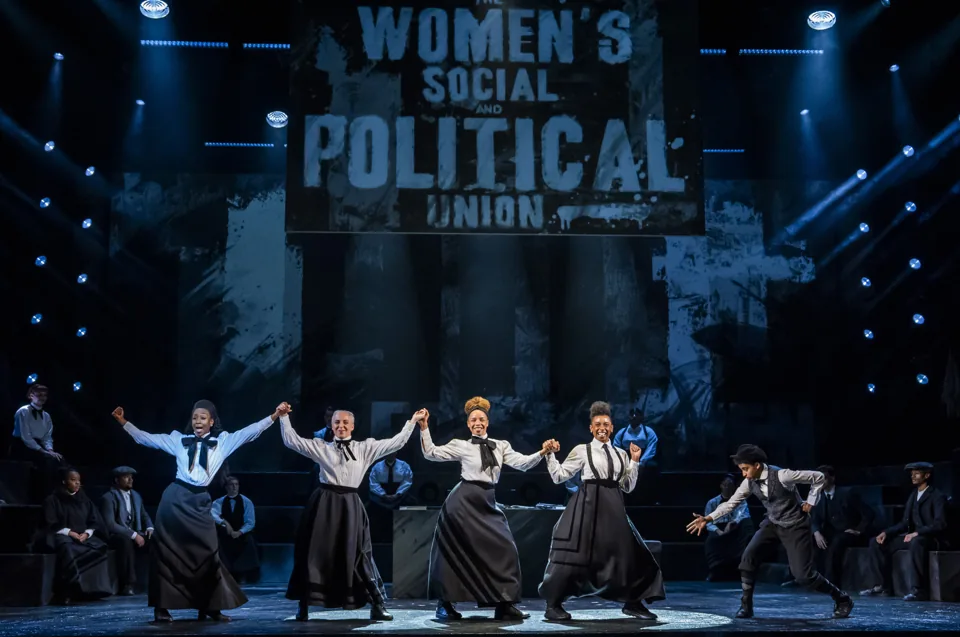Arms raised beneath the Women's Social and Political Union banner, Sylvia, Royal Albert Hall