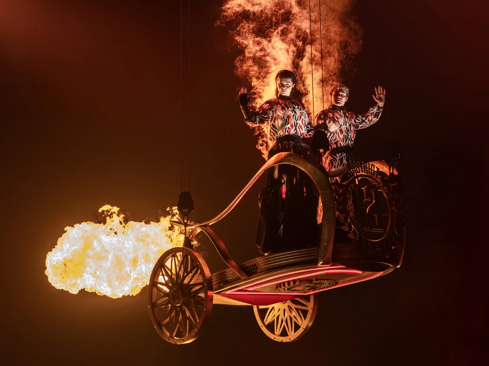 Katniss and Peeta on a flaming chariot in the tribute parade, Troubadour Canary Wharf