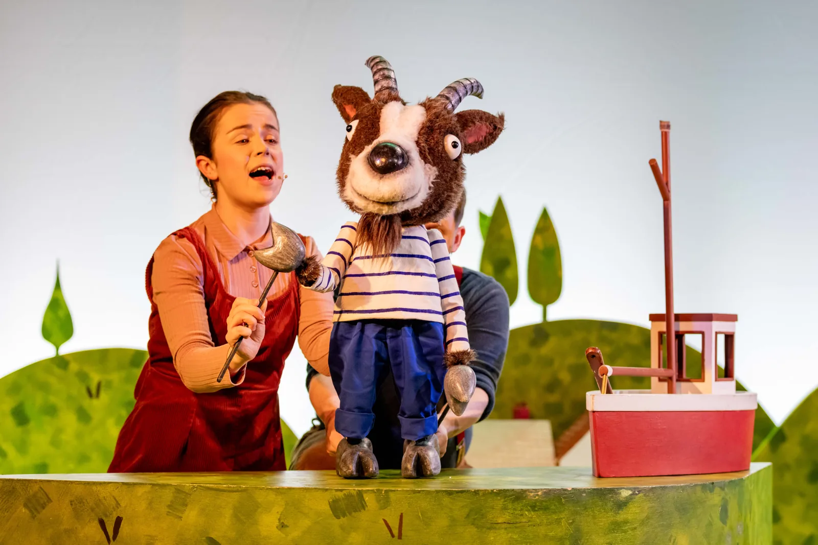 A puppeteer sings with the goat by his boat: The Smartest Giant in Town, St. Martin's