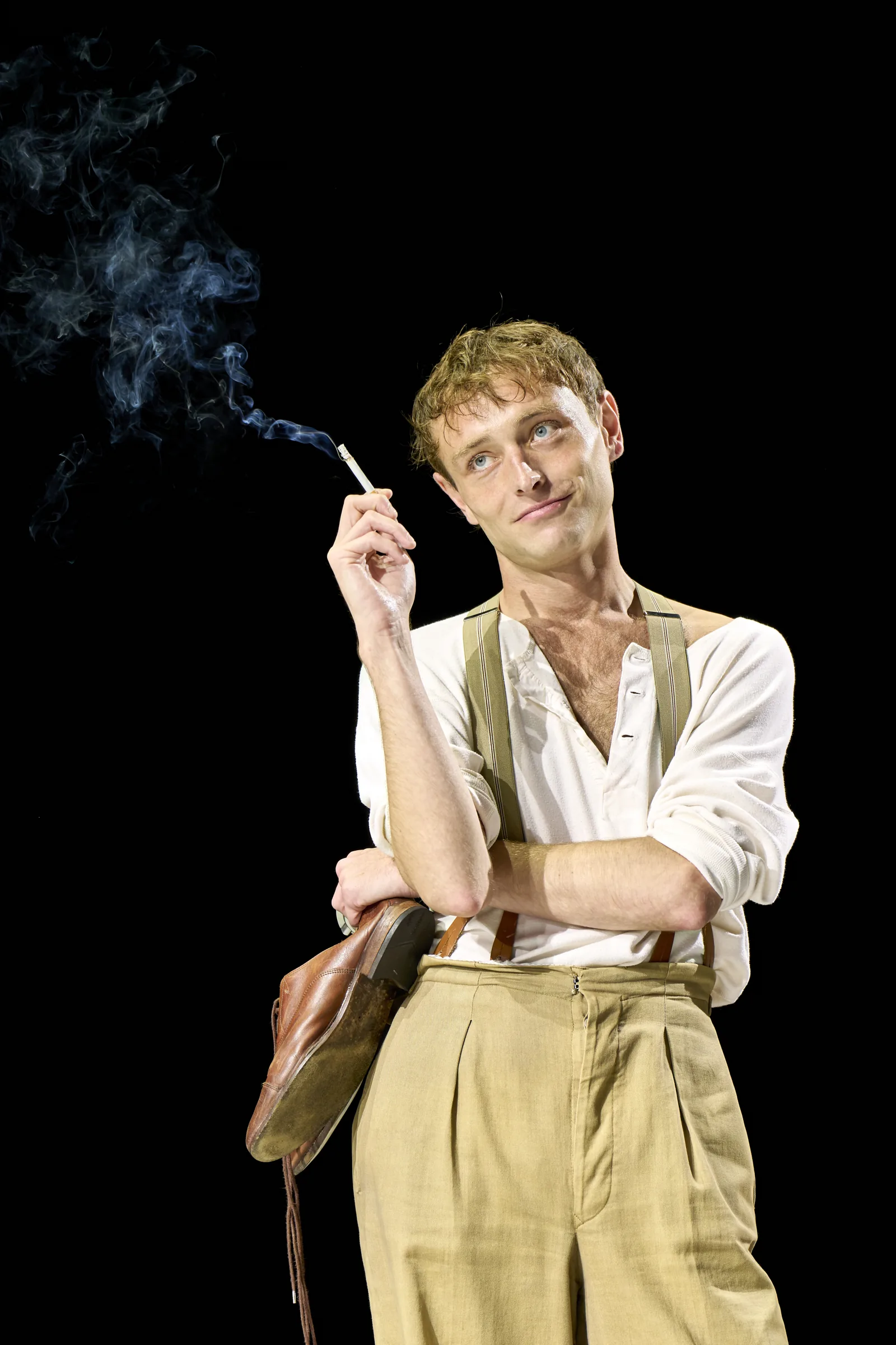 Thomas Flynn as Duncan Grant, cigarette raised, in The Standard of Living, Theatre Royal Haymarket