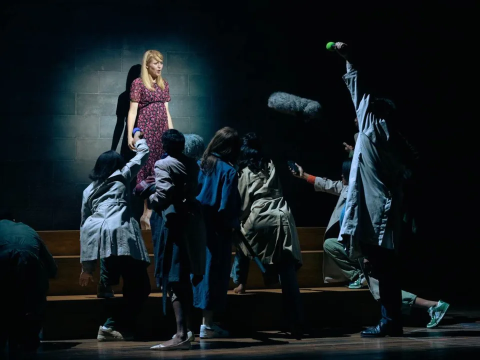 Antonia Bernath as Jessica Dunn faces a crowd of reporters in The Story, Olivier Theatre
